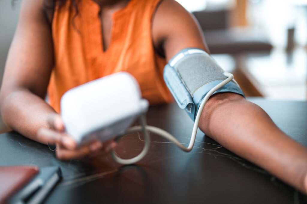 Woman checking her blood pressure with an at-home medical device