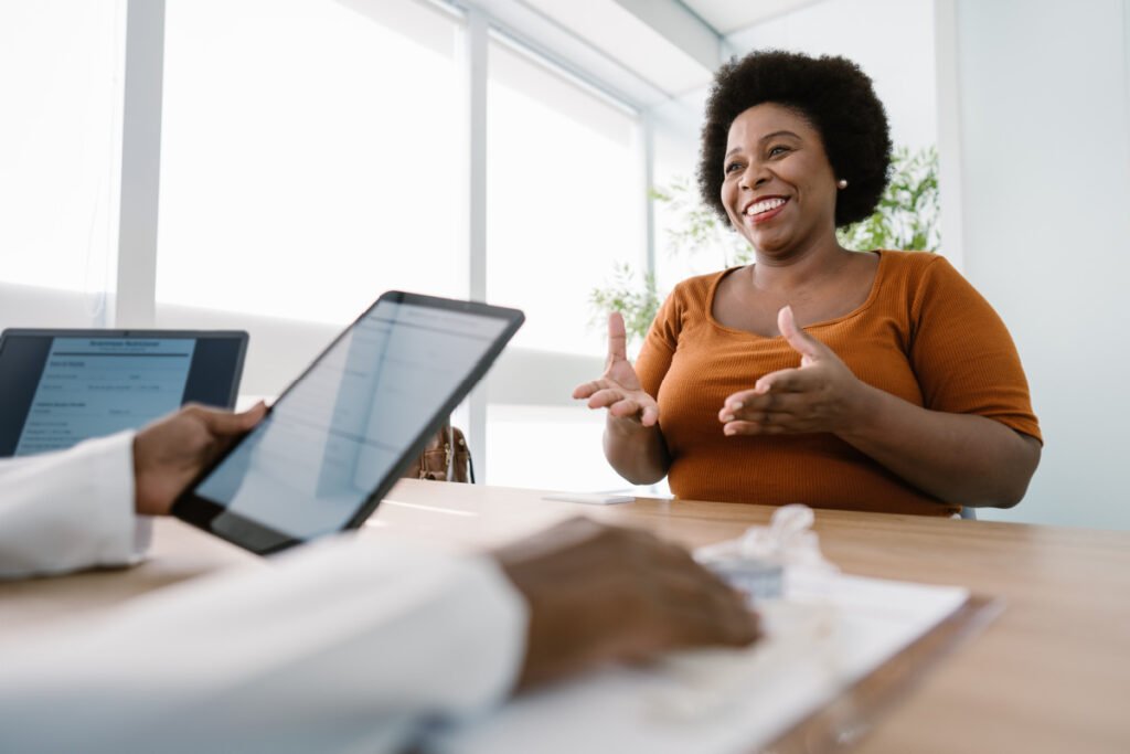 Woman during a consultation with a weight loss surgeon asking questions about her weight loss surgery options