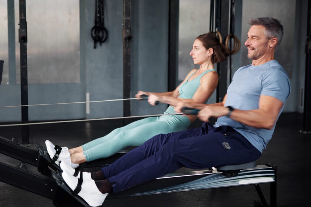 Couple working out on rowing machines together