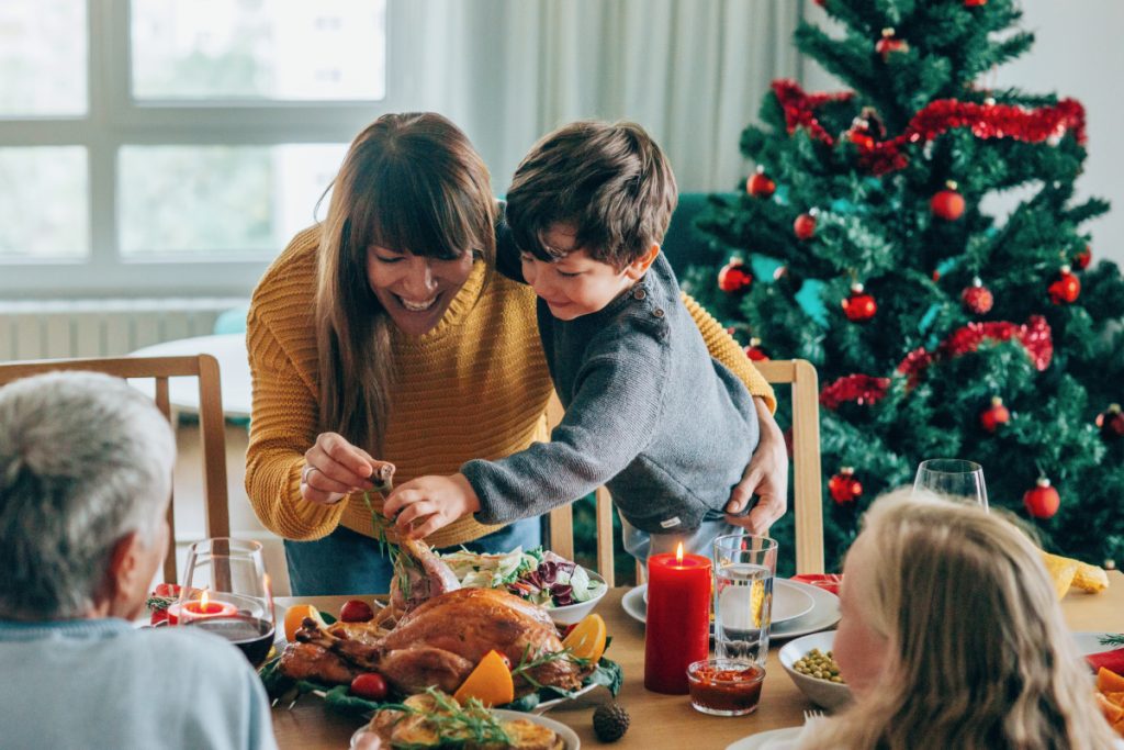 Woman eating Christmas dinner with her family