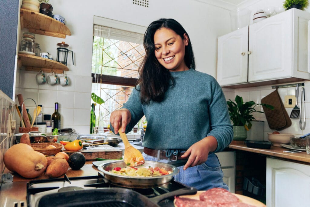 Woman cooking a healthy meal at home